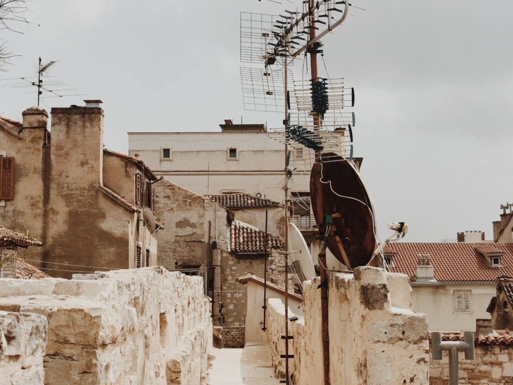 Traditional style TV aerial on a metal extension pole on top of a roof