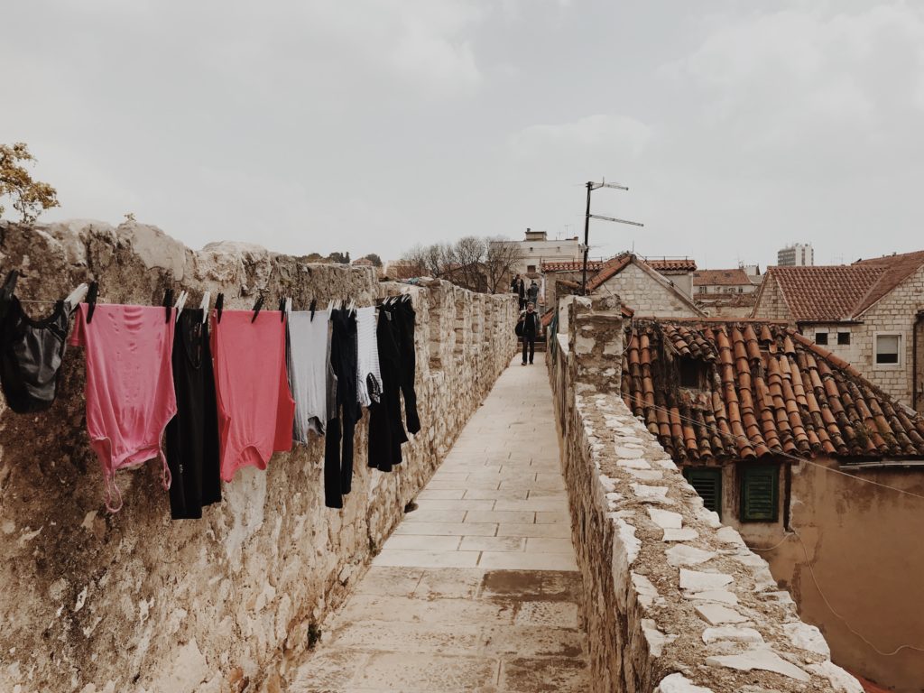 Drying laundry clothes hanging outside the window of an old building in the historic center