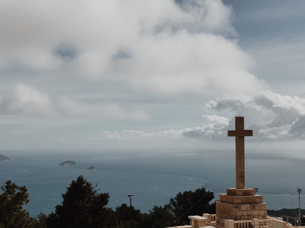 Giant christian white stone cross at the hill above Dubrovnik