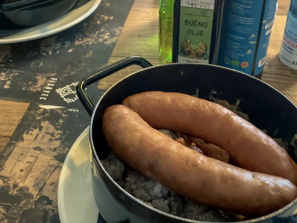 Kranjska klobasa, smoked sausage with sauerkraut and buckwheat mush