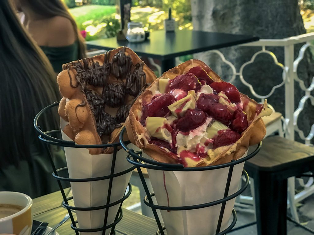 Bubble waffle with strawberries and chocolade close up