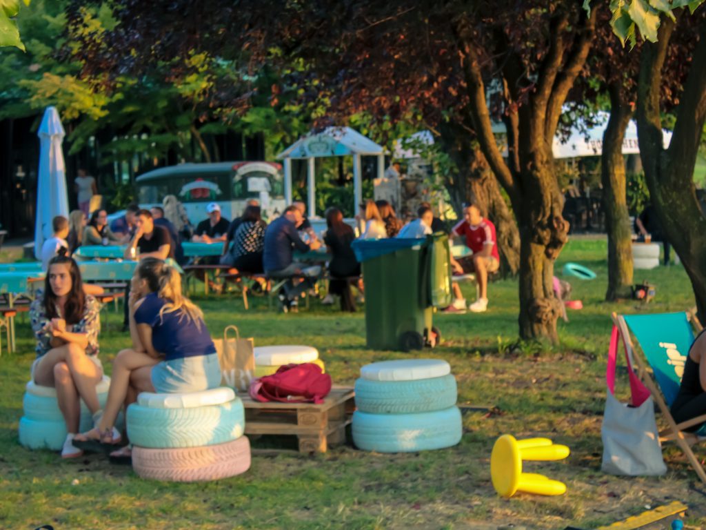 The colorful booths made of car tires and wooden pallets